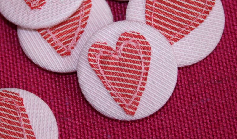 Heart badges close up on group on pink